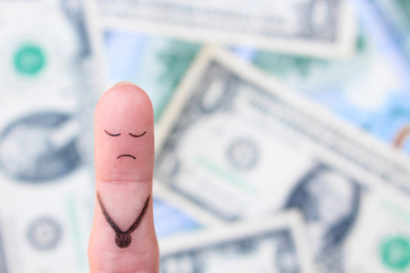Finger art of a lonely sad man on the background of money.の写真素材