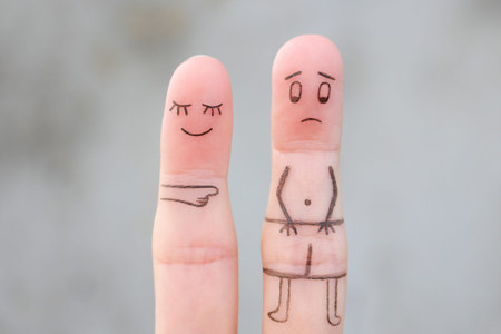 Finger art of the wife laughs at her husband. concept of impotence. Divorce.