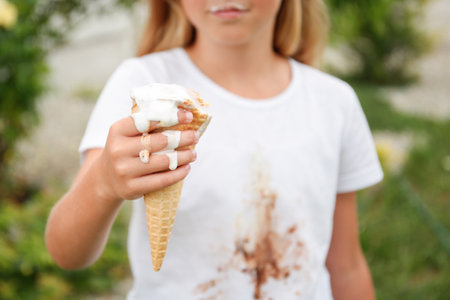 The child stained his clothes with ice cream.の写真素材