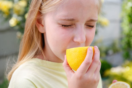 The child eats a sour lemon.の写真素材