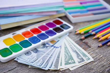 Office, school supplies and money on old wooden background. Concept is to buy stationary objects.の写真素材