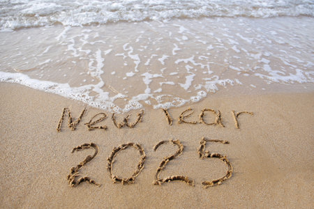 The description 2025 on the sand by the sea. Happy New Year.の写真素材