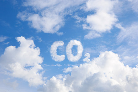 A blue sky with the chemical formula CO2 from white clouds. The concept of air pollution.の写真素材