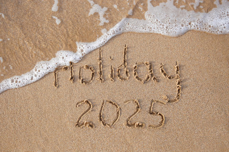 The inscription 2025, holiday on the sand by the sea. Happy New Year.の写真素材