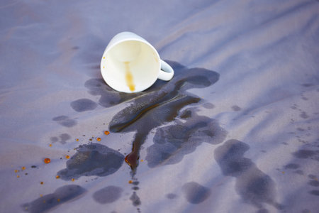 Spilled coffee on a gray bed.の写真素材