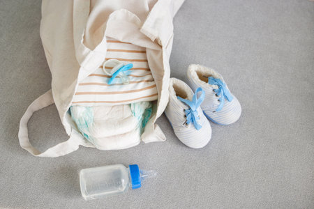 A bag for mom with newborn's belongings on a gray sofa.の写真素材