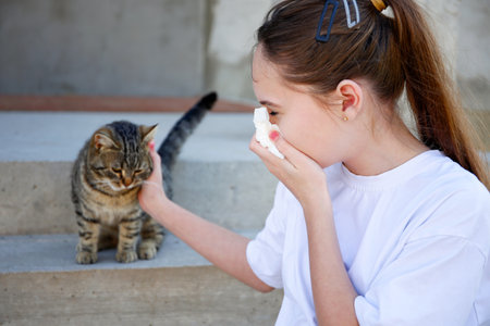 The teenager is allergic to a cat.の写真素材