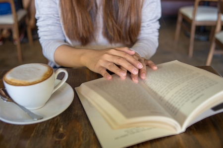 Reading book and enjoy hot cappuccino is young peoples hobbyの写真素材