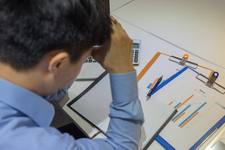 Businessman thinking about the sales reportの写真素材