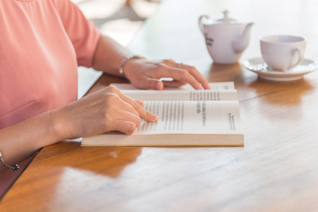 Close up of woman hand reading bookの写真素材