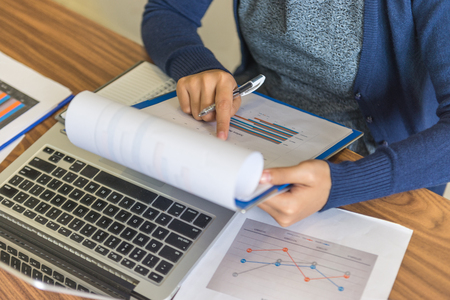 Woman holding and reading financial reportsの写真素材