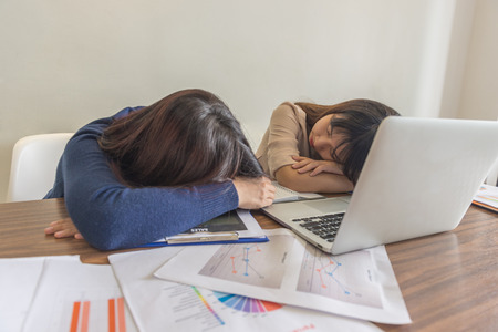 Asian business employees feel tired and sleepyの写真素材