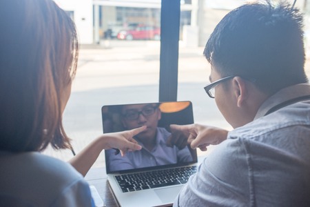 Business people discuss about problems on laptopの写真素材