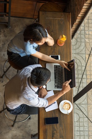 Man and woman pointing at laptop screenの写真素材
