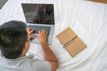 Overhead view of young man working on laptop