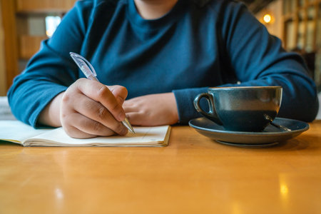 Young woman writing diary and enjoy new day