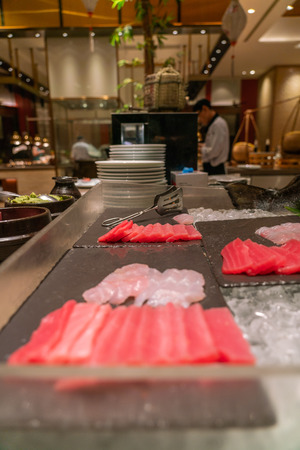 Vertical photo of Fresh Salmon Sashimi in the luxury buffet restaurantの写真素材