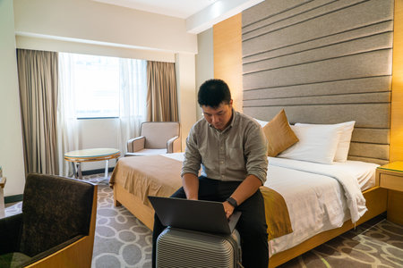 Young businessman working on laptop in the business tripの写真素材