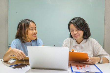 Smiling Asian businesswoman discuss about work in the officeの写真素材