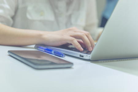 Young businesswoman working on laptop in the officeの写真素材