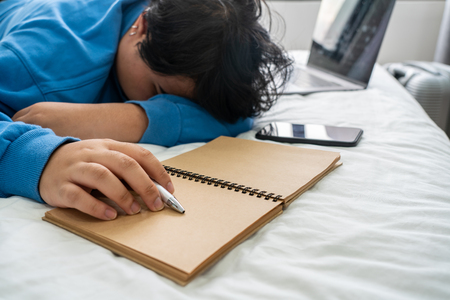 Close up photo of young girl sleeping on the bedの写真素材