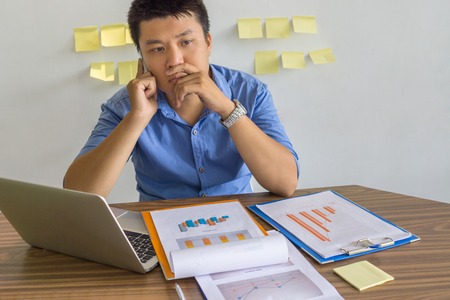 Young businessman answer phone call in the companyの写真素材