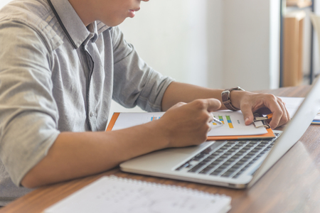 Businessman checking financial report with the penの写真素材