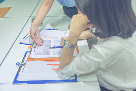 Vertical photo of Asian business team discuss about finance