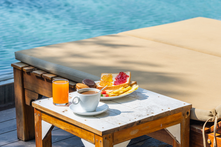 Delicious breakfast at resort with coffee, fruit and juicesの写真素材