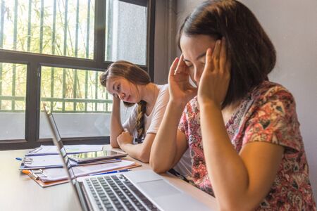 Frustrated office women feel headache and stress with workの写真素材