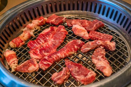 Raw beef slice on coal stove Japanese style barbecue yakinikuの写真素材