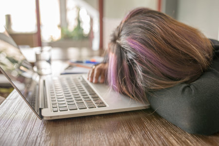 Young girl feel tired, frustrated and sleeping on laptop
