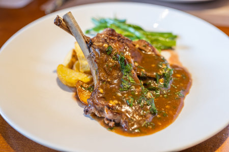 Delicious lamb chops and roasted potatoes on white plate