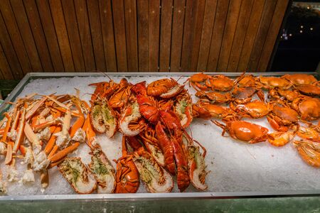 Delicious freshly cooked lobsters and crabs at seafood buffet restaurantの写真素材