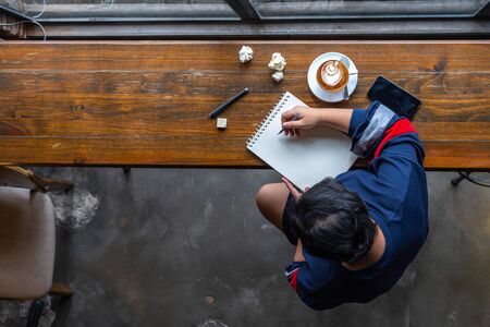 High angle view of Asian student drawing on sketchbookの写真素材