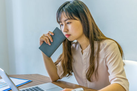Young beautiful woman working on laptop at office desk