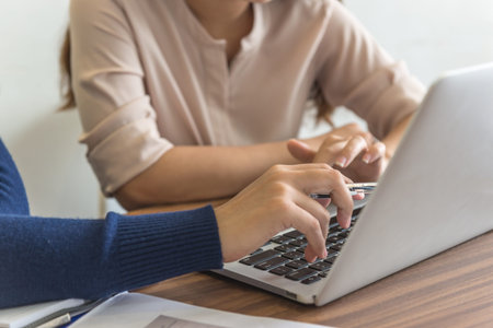 Close up of businesswoman hand pointing on laptop screen