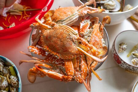 Bowl of delicious cooked crabs in seafood party at homeの写真素材