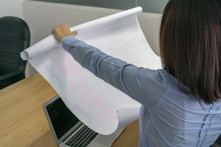 Close up photo of female hand holding project drawing paper