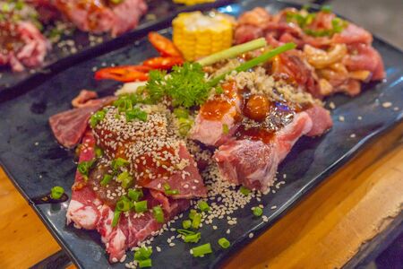 Plate of appetizing marinated beef and pork meat in barbecue partyの写真素材