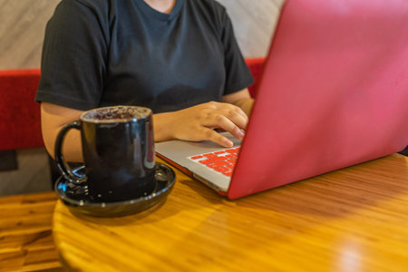 Close up photo of woman hand using laptop touchpad