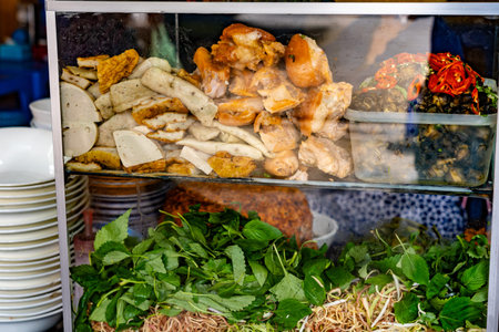 Snail, meats and vegetables at street food vendor in Vietnam