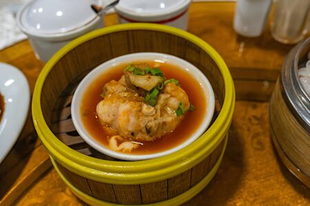Chinese steamed meat ball and sauce in dimsum steamer boxの写真素材
