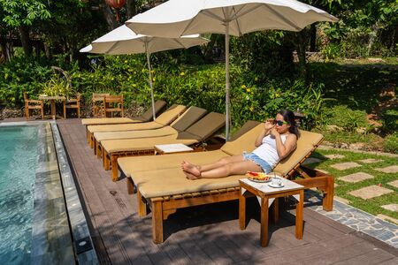 Asian woman enjoy vacation holiday at luxury resortの写真素材