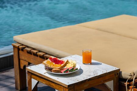 Delicious breakfast with sandwich, cake and fruit juiceの写真素材