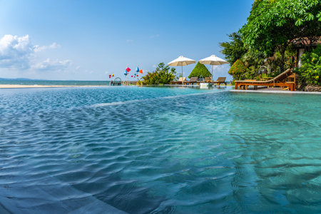 Infinity swimming pool at the beautiful beachの写真素材