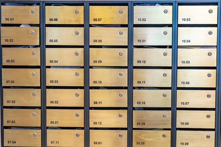 Metallic letter mailbox array at postal room in condominium buildingの写真素材