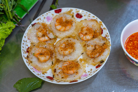 Plate of crispy fried shrimp tiny pancake- Banh Khotの写真素材