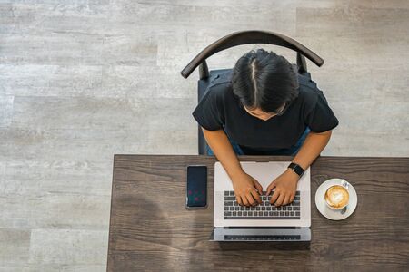 Top view photo of woman freelancer typing laptop at coffeeshopの写真素材