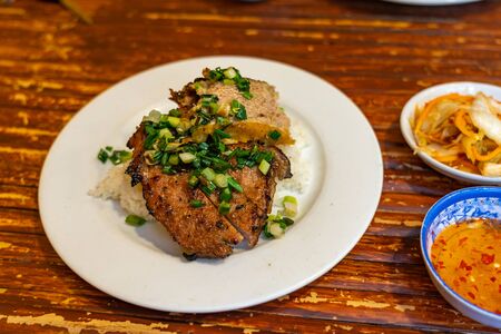 Vietnamese pork chop rice served with pickles and fish sauceの写真素材